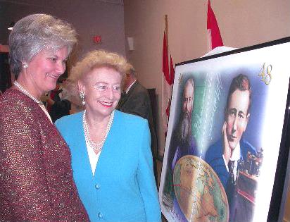 Lieutenant Governor Myra Freeman (left) and Princess Elettra Marconi-Giovanelli, Marconi's daughter, in Glace Bay, December 2002, admire a poster of a Canadian stamp commemorating the centennial of the first transatlantic wireless messages
